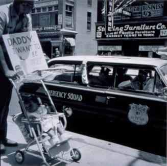 Daddy, I Want To Be Free Too: William Edwin Jones pushes daughter Renee Andrewnetta Jones during protest march on Main Street, Memphis, August, 1961, from the portfolio I am a Man